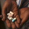 Nine-year-old Tumelo shows off antiretroviral (ARV) pills before taking his medication at Nkosi's Haven, south of Johannesburg